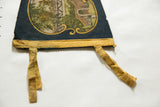 Vintage blue felt pennant's lower yellow border and creased ties.