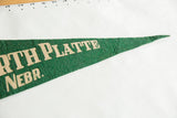 Napped wool texture of the green felt and off-white lettering on the North Platte pennant.
