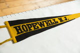 Black 'HOPEWELL N.J.' lettering on textured yellow felt of the souvenir pennant.