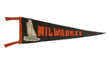 Circa 1920s black felt Milwaukee pennant with orange lettering, sailboat applique, 7x22 inches.