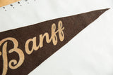 Dark brown felt pennant tip with subtle loss and tan Banff lettering.