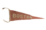 Antique Boston University felt pennant, muted red with beige BOSTON lettering, 5x16 inches.