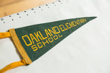 Vintage Oakland Elementary pennant measured against a ruler, confirming its 12-inch length.