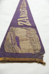 Distressed purple felt Zanesville pennant detail with Y Bridge graphic and frayed edge.