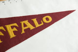 Close-up of gold 'FALO' letters on a vintage maroon felt Buffalo pennant.
