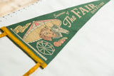 Green felt pennant showcasing cow, horse, ferris wheel, and yellow trim.