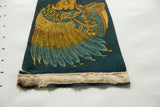 Bottom edge of the vintage felt pennant, showing beige binding and slight fraying.