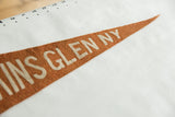 Pointed orange-brown felt pennant displaying 