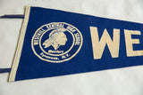 Detail of the vintage blue felt Westhill pennant, showing cream trim and Warriors logo.