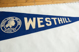 Detailed view of the vintage Westhill felt pennant, showing 'STHILL' in off-white on blue.