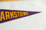 Clarkstown felt pennant close-up: yellow lettering on purple, showing felt texture.