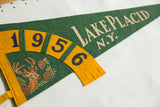 Vintage 1956 Lake Placid N.Y. felt pennant featuring deer and year on green.