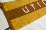 Stitched felt layers of antique Utica pennant showing brown, yellow, and light 