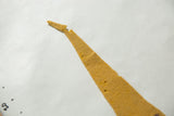 Goldenrod yellow felt pennant tip, showing small holes and slight tear.