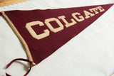 Sewn maroon felt and cream applique lettering of a vintage Colgate pennant.