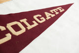 Vintage maroon felt pennant, raised beige LGATE letters with textured finish.