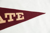 Maroon felt pointed tip of the vintage Colgate University pennant.