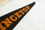 Close-up of circa 1930s orange block letters on black felt pennant.