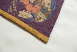 Close-up of an antique pennant's purple felt, yellow border, and 'Surf Bathing' illustration.