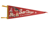Red vintage San Diego felt pennant showcasing a boat, toucan, buildings, and smiling sun.