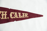 Detailed view of the maroon felt pennant tip with cream 'CALIF.' lettering and age-related wear.