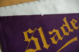 Small tear and felt texture on the top edge of the antique Slade School pennant.
