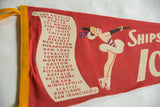 Red felt pennant with female ice skater, striped top, black gloves, and 