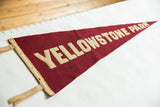 Yellowstone Park felt pennant with cream block letters on aged red wool textile.