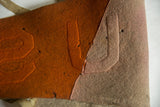 Raised U and S letters on orange and off-white antique felt pennant with patina.