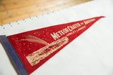 Faded red felt Meteor Crater of Arizona pennant tip with falling star imagery.