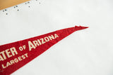 Pointed red felt tip of the Arizona pennant, featuring white lettering and minor loss.