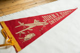 Red vintage felt JFK Airport pennant, highlighting plane design, boarding people, and yellow trim.