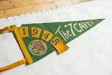 Textured green felt pennant with yellow 1948 numbers and cave graphic.