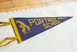 Detailed view of the yellow canoe graphic and side ties on the blue felt pennant.