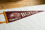 Mid-century burgundy felt pennant with pinkish buffalo graphic and orange ties.