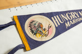 Vintage felt pennant close-up showing Native American graphic, 'Hungry M' text, yellow hoist.