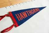 Red HAWTHORNE lettering on vintage blue felt pennant with red trim.