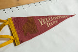 Red felt pennant with brown bear graphic and yellow ties, circa 1940s.