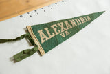 Close-up of vintage Alexandria VA pennant, highlighting white lettering and green felt ties.