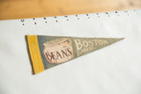 Vintage circa 1950s Boston felt pennant: yellow band, beans pot, slate gray background.
