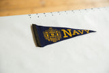 Dark blue felt pennant with yellow United States Navy crest and 'NAVY' lettering.