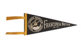 Vintage Franconia N.H. felt pennant, black with white Cannon Mountain emblem and yellow trim. 5x12.