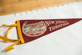 Yellow felt ties and detailed river scene on the vintage New Jersey Turnpike pennant.