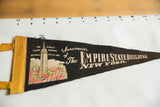 Vintage Empire State Building pennant, yellow felt ties, detailed building and text.