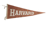 Vintage Harvard Felt Flag Pennant with white block lettering on a dusty terra-cotta background, 11x28.