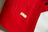 Red felt Kamp Kill Kare pennant with black stitched letters and The Felt Crafters label.