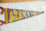 Circa 1940s felt pennant showing iconic NYC buildings in yellow and orange, with red ties.