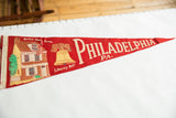 Red felt vintage pennant detail with Betsy Ross House and Liberty Bell imagery.