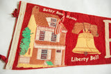 Golden yellow Liberty Bell illustration with crack on vintage red felt pennant.