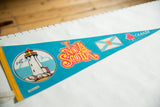 Blue felt Nova Scotia pennant with a detailed lighthouse graphic and bright yellow left edge.